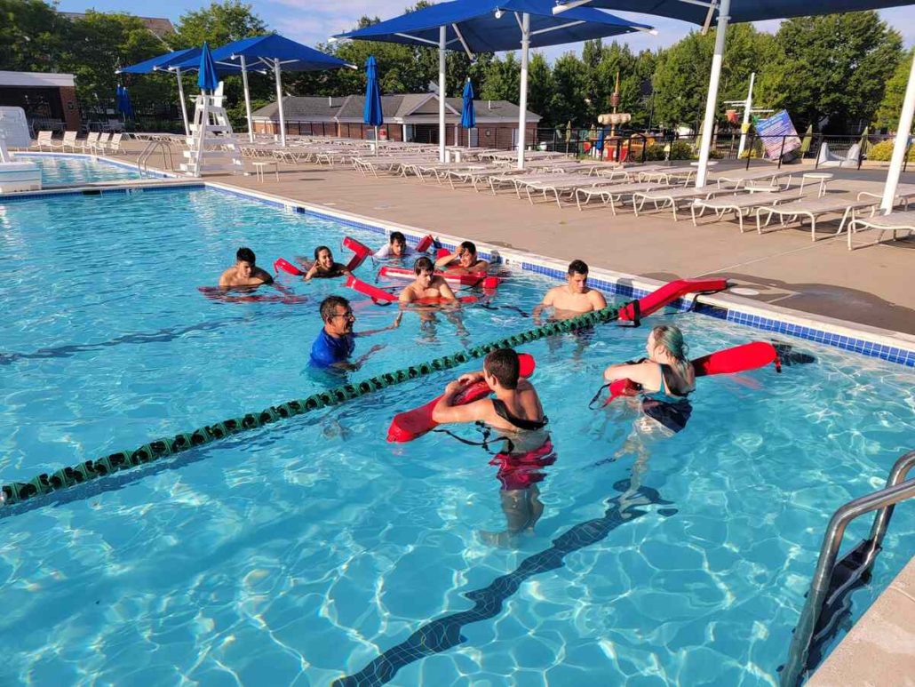 instructor and swimmers in pool during an american red cross lifeguarding course